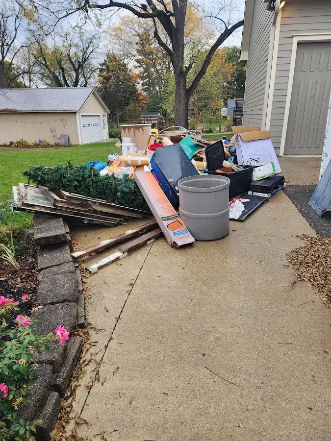 Dumpster being loaded with debris for Estate Cleanout Dumpster Rental in Walton